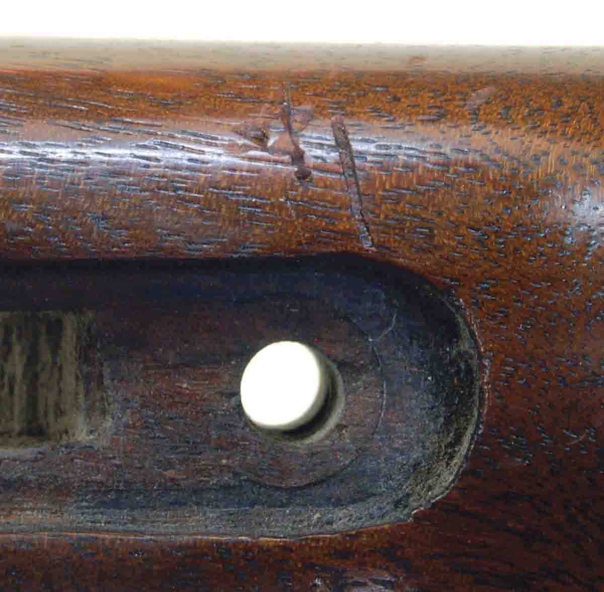 Scratches on this old Springfield stock show signs of a screwdriver slipping out of the screw slot.